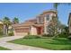 Two-story house with a two-car garage at 18051 Java Isle Dr, Tampa, FL 33647