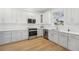 Modern kitchen with white cabinets, stainless steel appliances, and quartz countertops at 18051 Java Isle Dr, Tampa, FL 33647