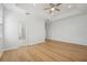 Main bedroom with hardwood floors, ceiling fan and en-suite bathroom at 18051 Java Isle Dr, Tampa, FL 33647