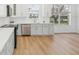 Modern kitchen featuring white cabinets, stainless steel appliances, and quartz countertops at 18051 Java Isle Dr, Tampa, FL 33647