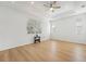 Large bedroom with hardwood floors, multiple windows, and ceiling fan at 18051 Java Isle Dr, Tampa, FL 33647