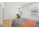 Bedroom with a yellow desk, wood flooring, and two windows at 18051 Java Isle Dr, Tampa, FL 33647