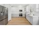 Modern kitchen with white cabinets, stainless steel appliances and quartz countertops at 18051 Java Isle Dr, Tampa, FL 33647