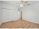 Large bedroom with light walls, wood flooring and access to another room at 18051 Java Isle Dr, Tampa, FL 33647