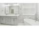 Modern bathroom with double vanity and free-standing tub at 18051 Java Isle Dr, Tampa, FL 33647