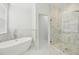 Spa-like bathroom with marble tile and a large shower at 18051 Java Isle Dr, Tampa, FL 33647