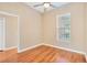 Simple bedroom with hardwood floors and a window with blinds at 16315 Sambourne Ln, Tampa, FL 33647