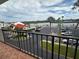 Condo balcony overlooking a parking lot and waterfront view, offering a glimpse of the waterway at 19111 Vista Bay Dr # 308, Indian Shores, FL 33785