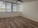 Bedroom features wood flooring and window with blinds, creating a comfortable retreat at 19111 Vista Bay Dr # 308, Indian Shores, FL 33785