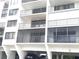 Multi-story building exterior showing balconies, car parking, and a well-maintained facade at 19111 Vista Bay Dr # 308, Indian Shores, FL 33785