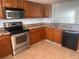 Kitchen featuring wood cabinets, granite countertops, and stainless steel appliances at 19111 Vista Bay Dr # 308, Indian Shores, FL 33785