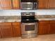Updated kitchen with stainless steel oven, microwave, and granite countertops adding style to the space at 19111 Vista Bay Dr # 308, Indian Shores, FL 33785