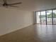 Bright living room featuring neutral walls, tile flooring, and sliding glass doors to a balcony at 19111 Vista Bay Dr # 308, Indian Shores, FL 33785