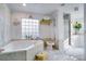 Large bathroom with a corner tub and updated fixtures at 2406 S Clark Ave, Tampa, FL 33629