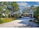 Mid-century modern home with landscaped yard and gated entrance at 2406 S Clark Ave, Tampa, FL 33629