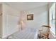 Bright bedroom with a double door closet and rocking chair at 5648 Sunset Falls Dr, Apollo Beach, FL 33572
