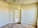 Simple carpeted bedroom with door to another room at 5648 Sunset Falls Dr, Apollo Beach, FL 33572