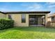 Private screened patio with lush green lawn at 5648 Sunset Falls Dr, Apollo Beach, FL 33572