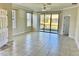Bright living room with tile floors and sliding glass doors leading to backyard at 5648 Sunset Falls Dr, Apollo Beach, FL 33572