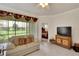 Living room with light sofas, backyard view, and access to bedroom at 5648 Sunset Falls Dr, Apollo Beach, FL 33572