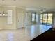 Spacious living room with tile floors and sliding doors at 5648 Sunset Falls Dr, Apollo Beach, FL 33572