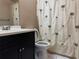 Bathroom with vanity, toilet and shower/tub with a shower curtain at 7140 Orchid Lake Rd, New Port Richey, FL 34653