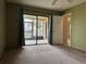 Bedroom with access to a screened patio with sliding glass doors at 7140 Orchid Lake Rd, New Port Richey, FL 34653
