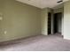 Carpeted bedroom with built in shelving and closet space at 7140 Orchid Lake Rd, New Port Richey, FL 34653