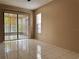 Bright living room featuring tile flooring and sliding glass door to outdoor space at 7140 Orchid Lake Rd, New Port Richey, FL 34653