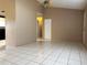 Open-concept living room showcasing tile flooring, ceiling fan and view to kitchen at 7140 Orchid Lake Rd, New Port Richey, FL 34653