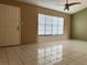 Bright living room with tile flooring, large window and ceiling fan at 7140 Orchid Lake Rd, New Port Richey, FL 34653