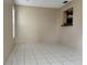 Clean-lined living room with tile flooring and view to the kitchen at 7140 Orchid Lake Rd, New Port Richey, FL 34653