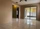 Open-concept living room showcasing tile flooring and access to screened patio at 7140 Orchid Lake Rd, New Port Richey, FL 34653