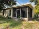 Enclosed screened porch providing an excellent place to relax while enjoying the outdoors at 7140 Orchid Lake Rd, New Port Richey, FL 34653