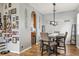Dining area with a dark wood table, gray chairs, and a view to kitchen at 30552 Latourette Dr, Wesley Chapel, FL 33545