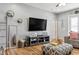 Cozy living room featuring hardwood floors, a large TV, and comfortable seating at 30552 Latourette Dr, Wesley Chapel, FL 33545