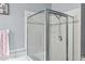 Glass enclosed shower with neutral tile at 30552 Latourette Dr, Wesley Chapel, FL 33545