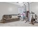 Bright home gym with exercise equipment and a couch at 30552 Latourette Dr, Wesley Chapel, FL 33545
