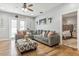 Gathering room with gray sectional sofa and access to patio at 30552 Latourette Dr, Wesley Chapel, FL 33545