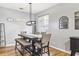 Dining room with hardwood floors and a dark wood table with seating for six at 30552 Latourette Dr, Wesley Chapel, FL 33545