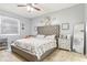 Main bedroom with a large bed, plenty of light, and a full-length mirror at 30552 Latourette Dr, Wesley Chapel, FL 33545