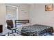 Small bedroom with a double bed, office chair, and window coverings at 30552 Latourette Dr, Wesley Chapel, FL 33545