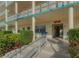 Exterior view of condo building with landscaped grounds and accessible entryway at 2960 59Th S St # 509, Gulfport, FL 33707