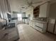 Kitchen with white cabinets and granite countertops, needing repairs at 620 Dalton Blvd, Port Charlotte, FL 33952