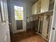 Laundry room with damaged walls and flooring at 620 Dalton Blvd, Port Charlotte, FL 33952