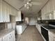 Kitchen with white cabinets and granite countertops needing repairs at 620 Dalton Blvd, Port Charlotte, FL 33952