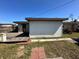 Features a wooden deck and a white building in the backyard at 620 Dalton Blvd, Port Charlotte, FL 33952