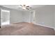 Large bedroom with carpet, ceiling fan and access to hallway at 12110 Miracle Mile Dr, Riverview, FL 33578