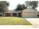 One-story home with attached garage and stone accents at 7140 Orchid Lake Rd, New Port Richey, FL 34653