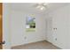 Simple bedroom with tile floor, window, and closet with louvered doors at 15901 Manning Dr, Tampa, FL 33613